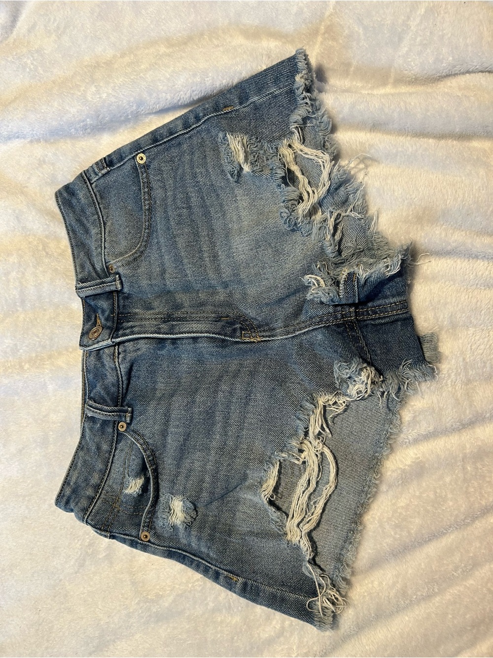 High-Rise Distressed Denim Shorts in Blue